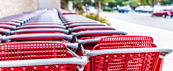 Red shopping carts in a row outside store
