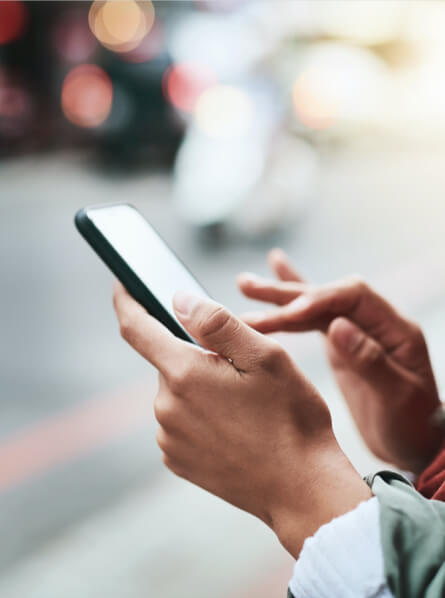 Person outside on street using a smart phone