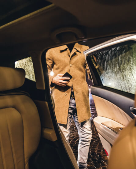 Person entering back seat of a car