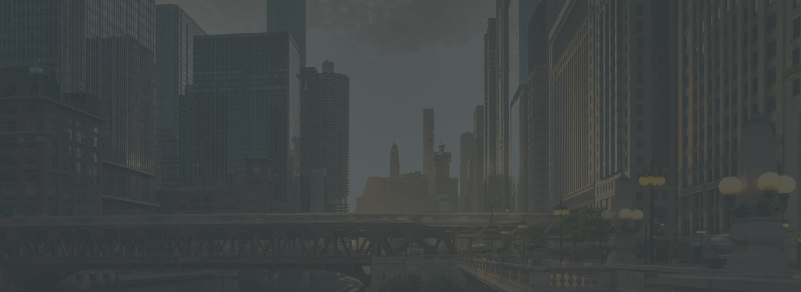 Chicago riverwalk with downtown skyscrapers and bridge.