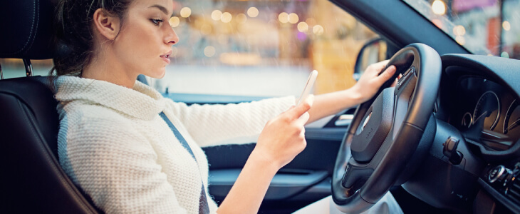Woman driving distracted by cellphone.