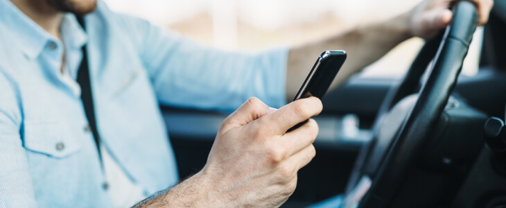 Man using cellphone while driving.