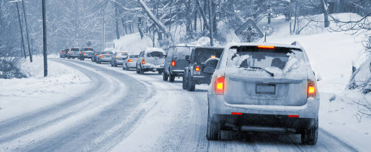 Cars lined up in bumper to bumper traffic due to snow storm