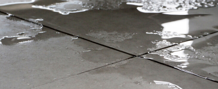 Close up of tile floor with water on it