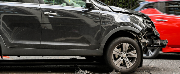 Black crossover vehicle with damage to front bumper