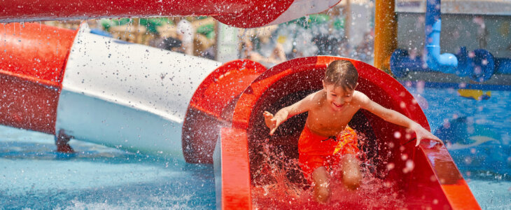 Young boy on a waterslide at a water park