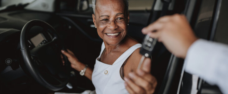 Senior woman renting a car